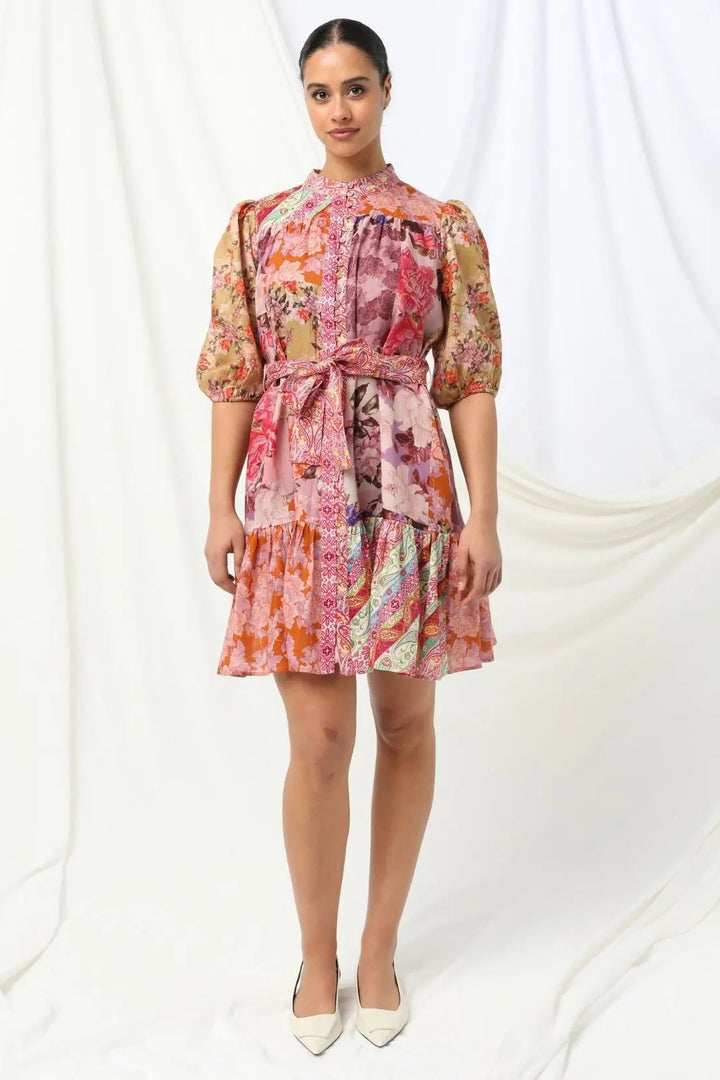 Woman wearing a colorful floral dress on a white background