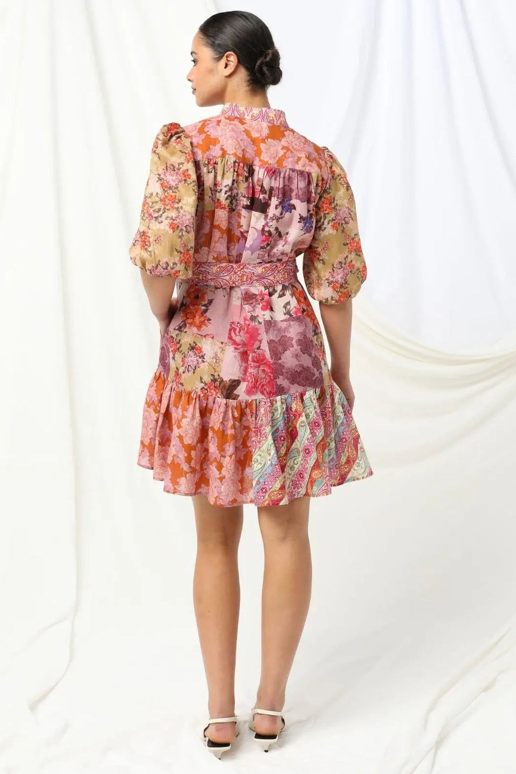 Woman wearing a floral dress against a white background