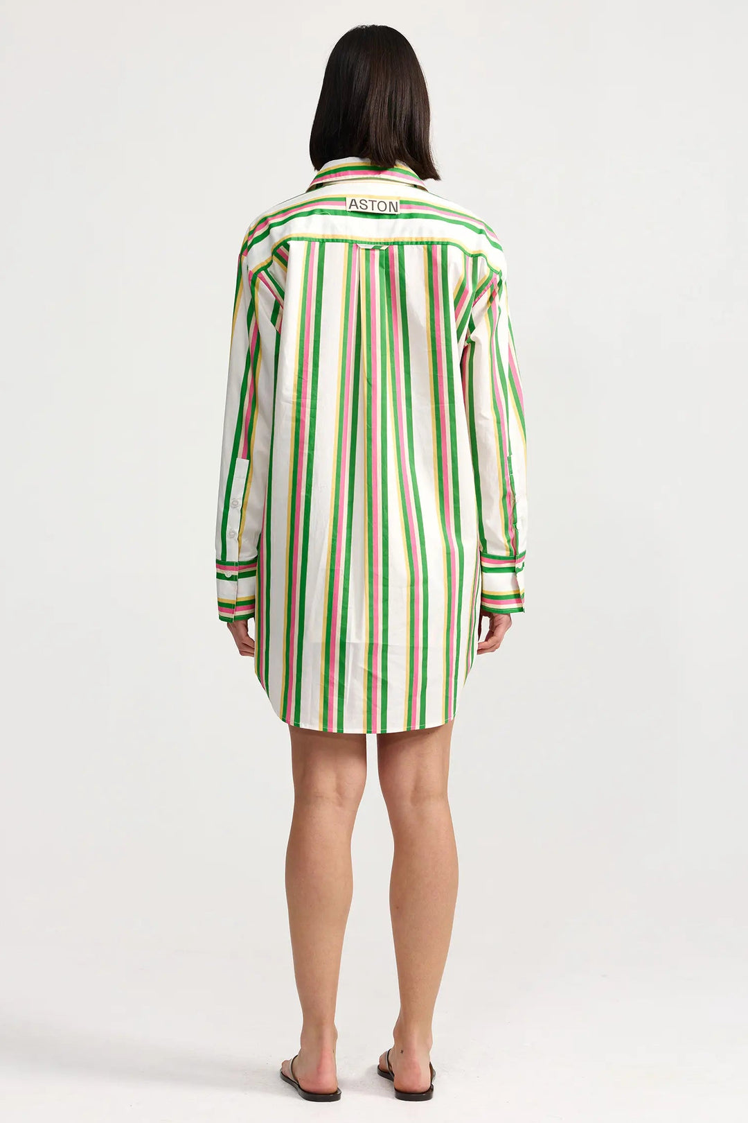 Person wearing a green and white striped shirt dress on a white background. Aston Studio Buddy Shirt Meadow Sorbet