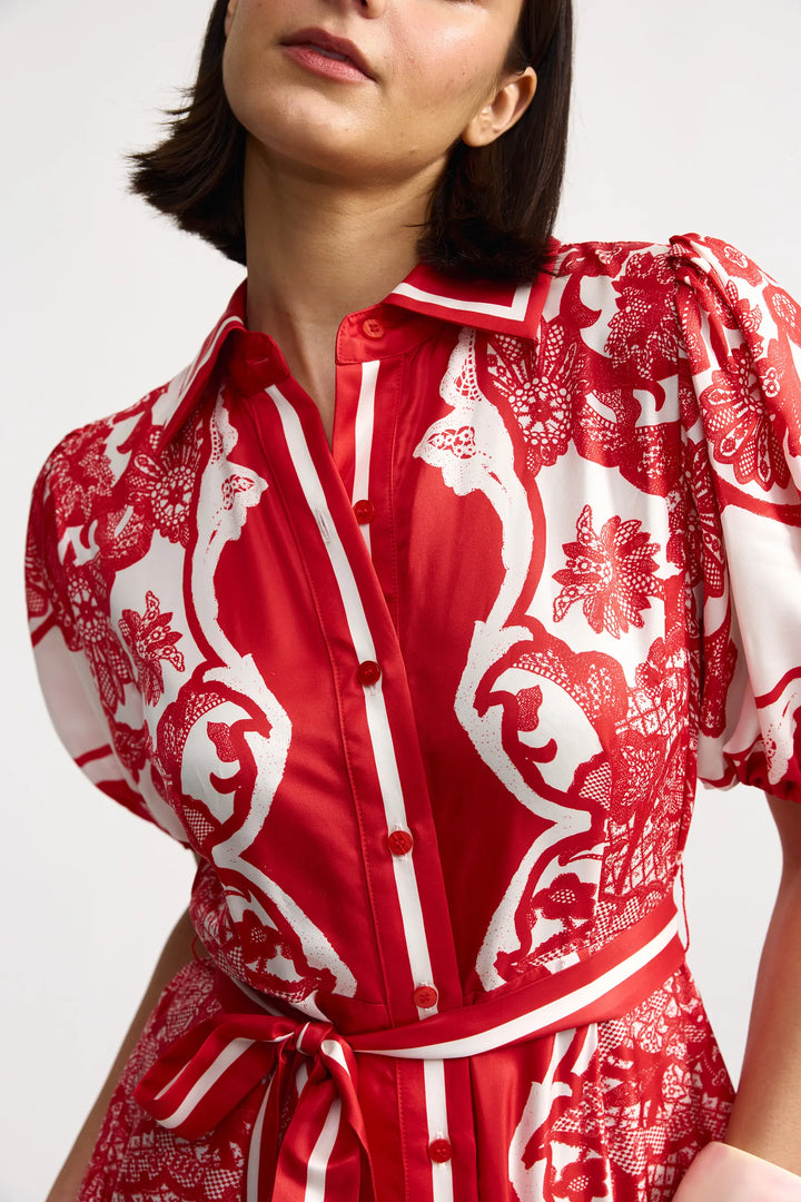Red and white patterned shirt worn by a person on a white background
