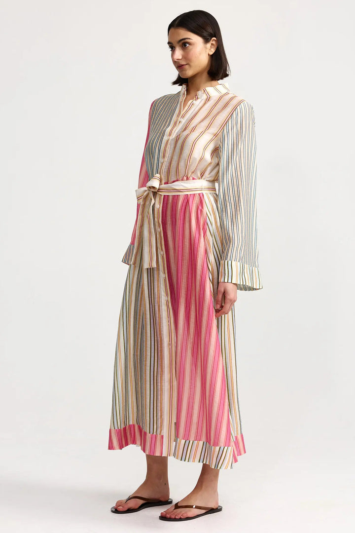 Woman wearing a striped dress with a white background. Aston Studio Neotta Dress Peony Multi Stripe