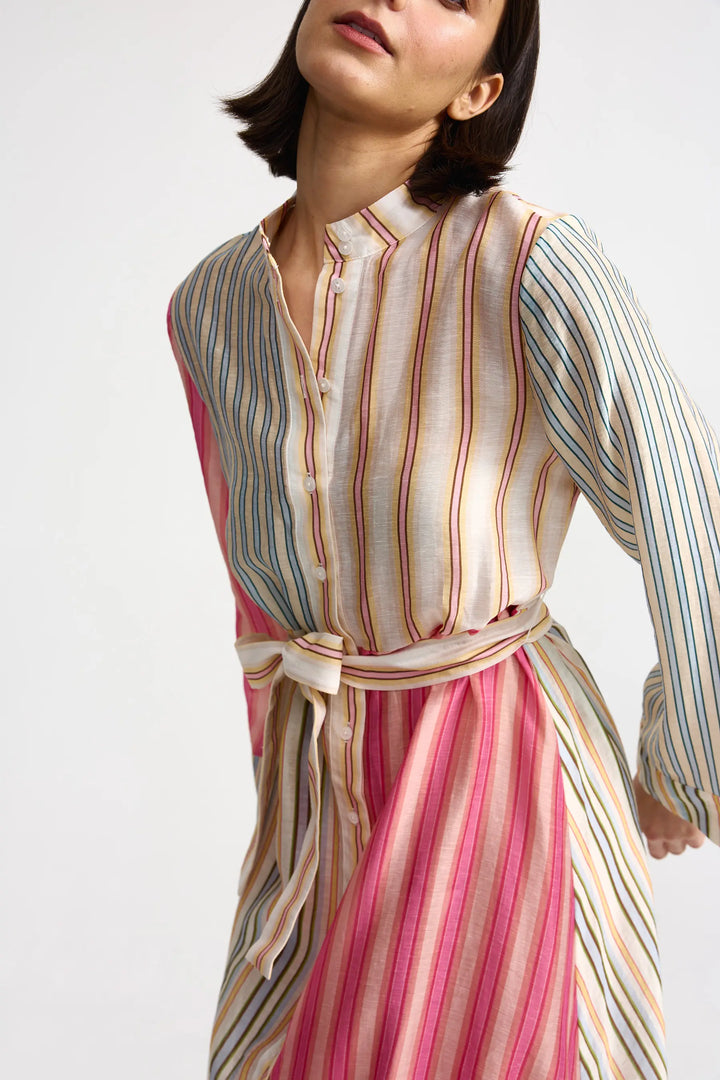 Woman wearing a multicolored striped dress on a white background. Aston Studio Neotta Dress Peony Multi Stripe