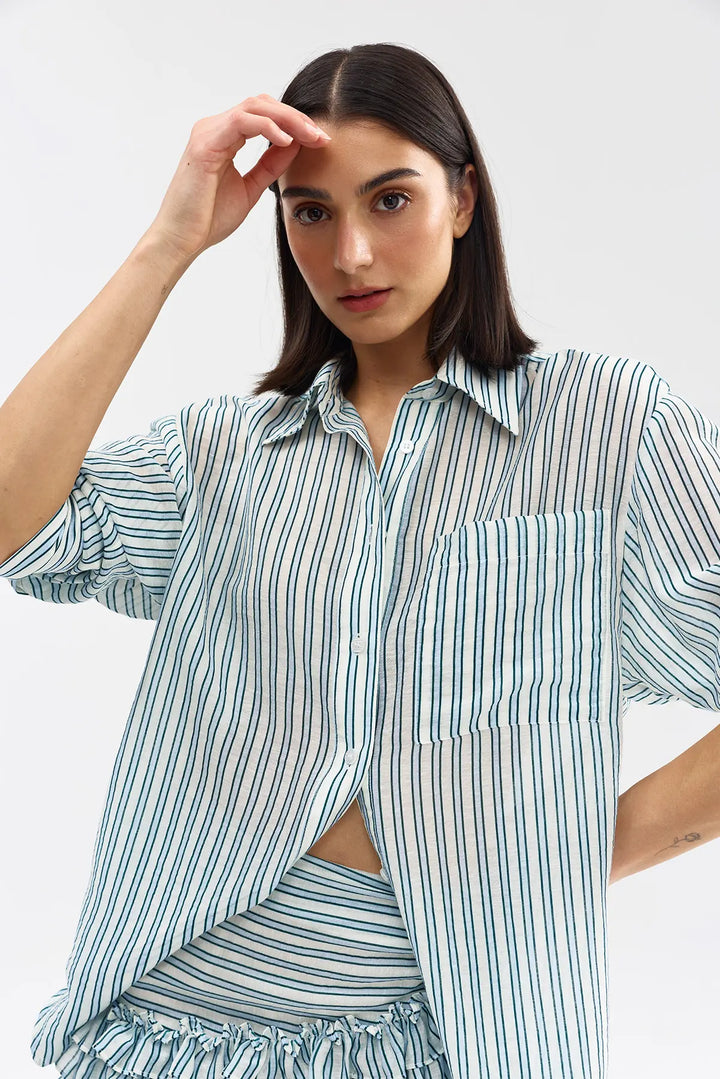 Woman wearing a striped shirt and skirt set on a white background