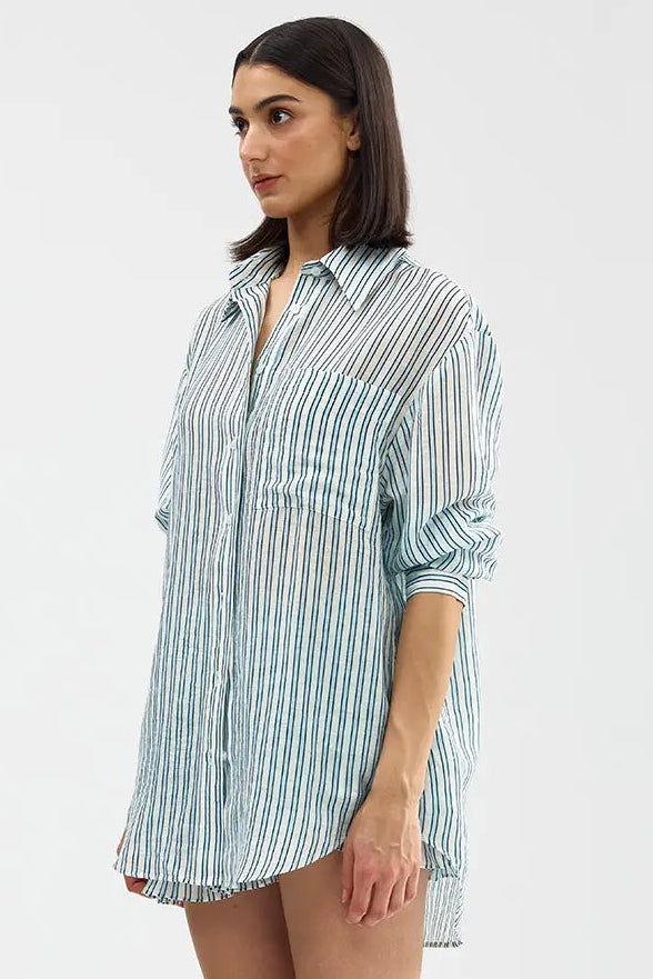 Woman wearing a striped shirt dress on a white background