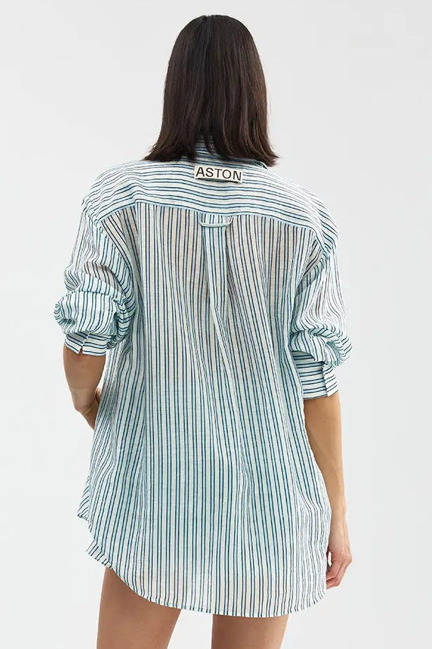 Person wearing a striped shirt and shorts on a white background