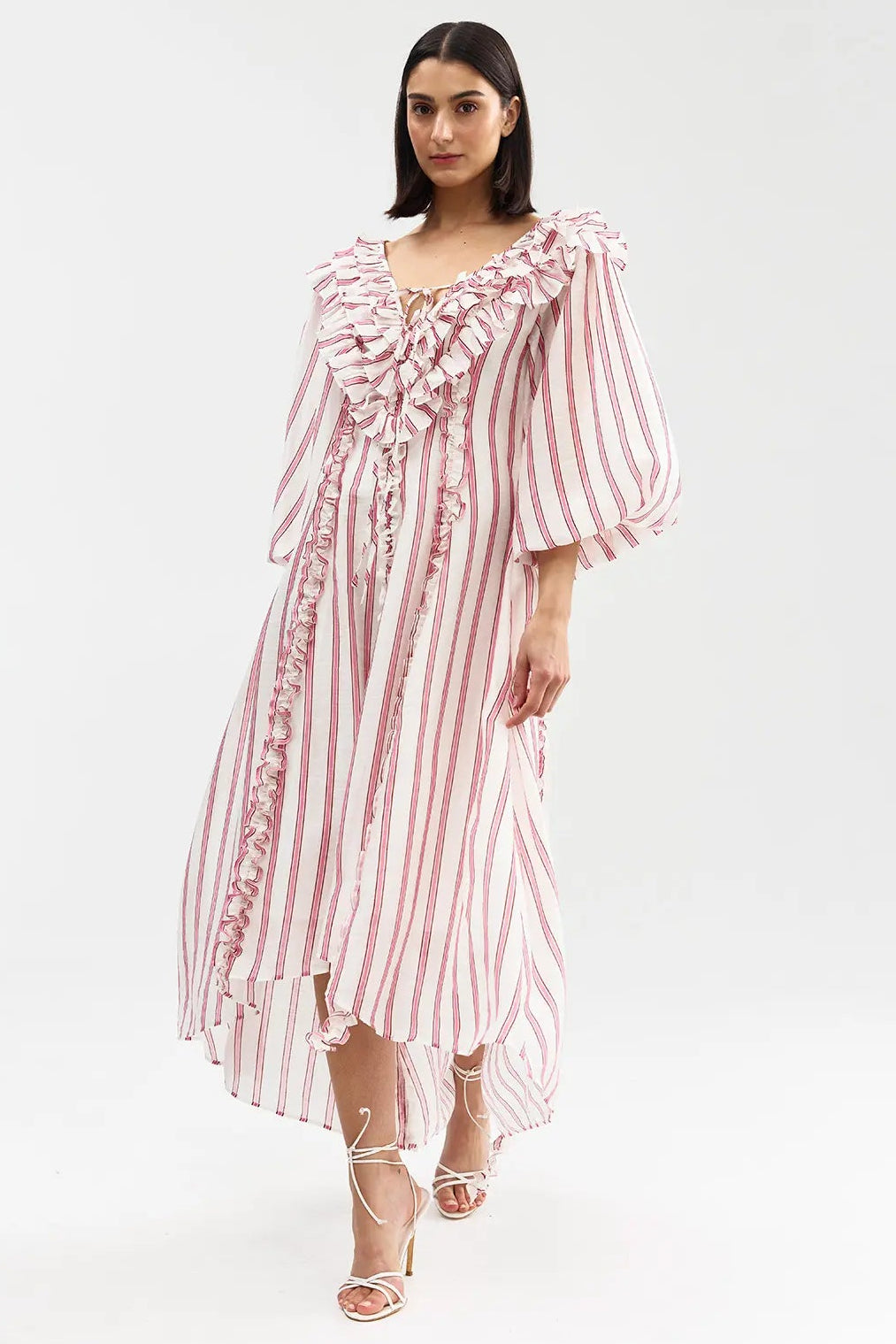 Woman wearing a red and white striped dress on a white background
