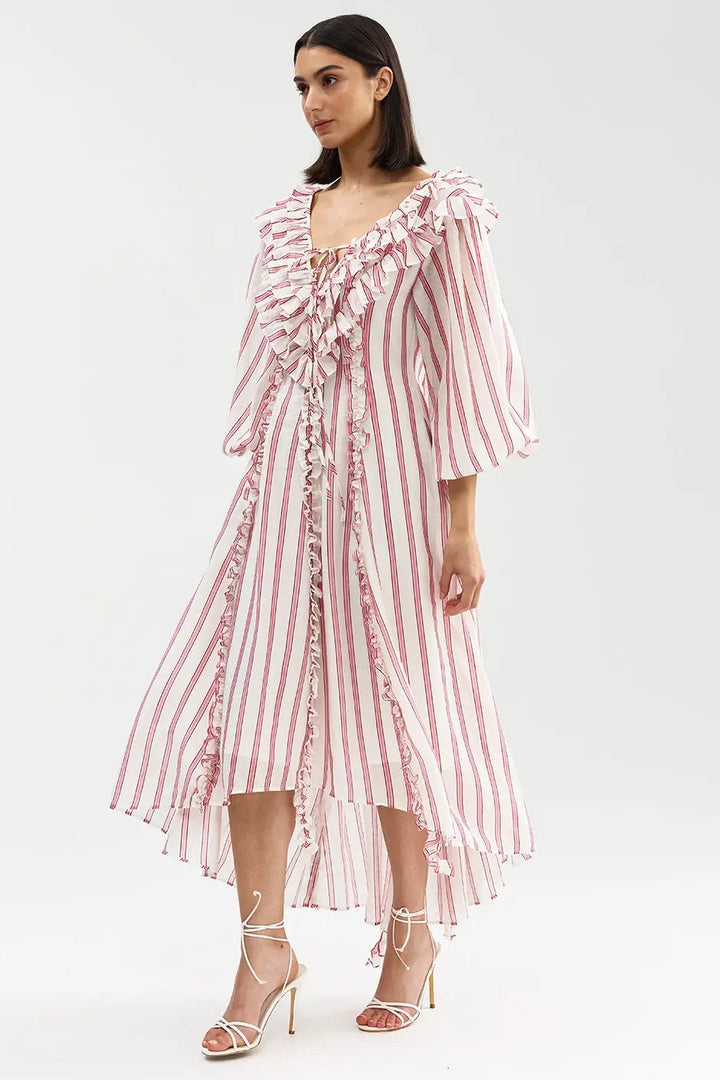 Woman wearing a pink and white striped dress on a white background