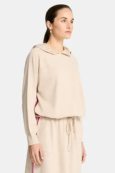 Woman wearing a beige outfit with a white background