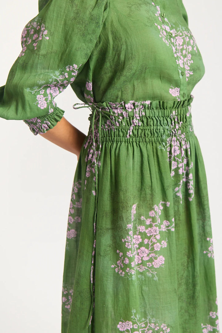Green dress with floral patterns on a white background