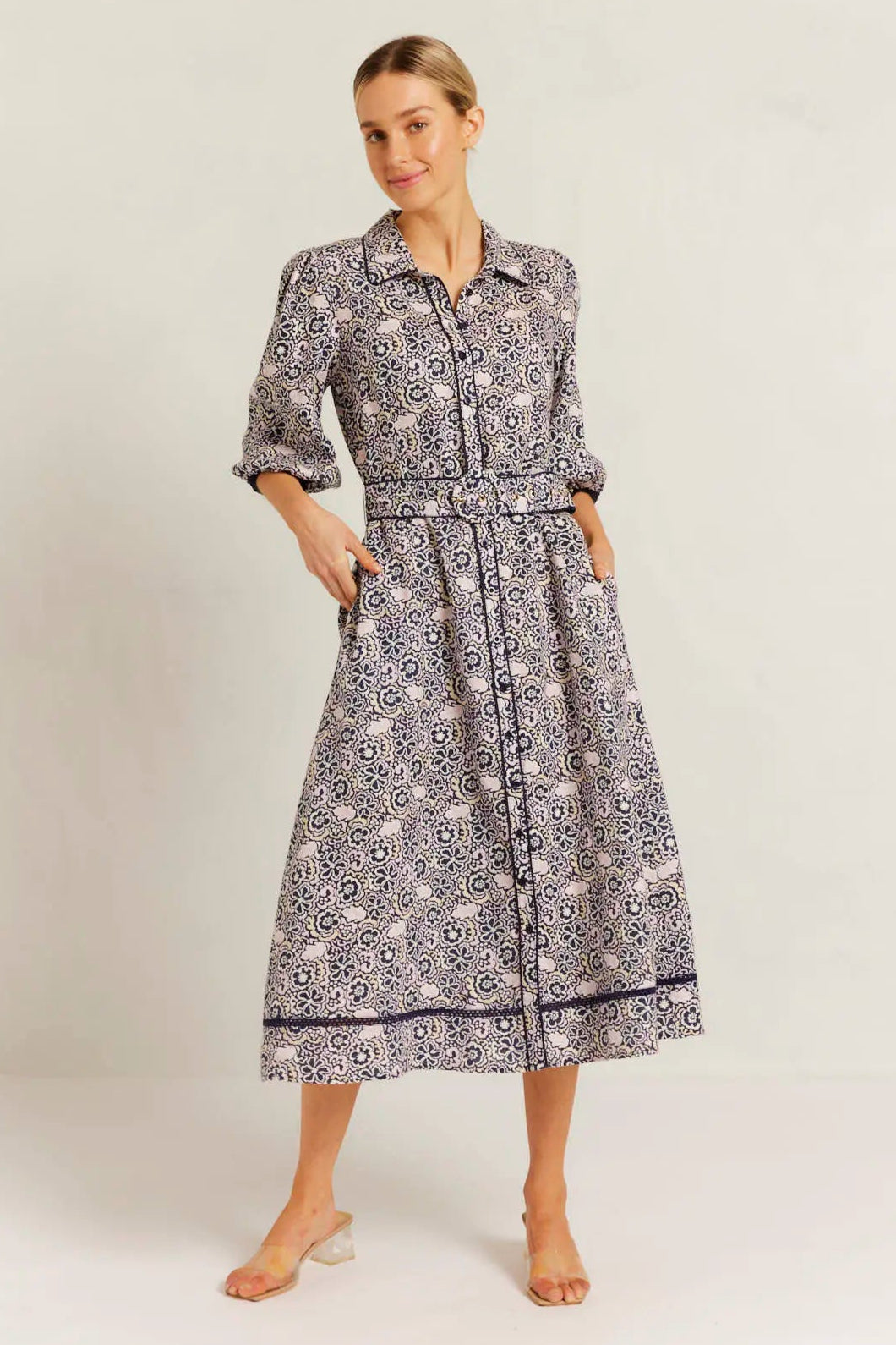 Woman wearing a patterned dress on a white background