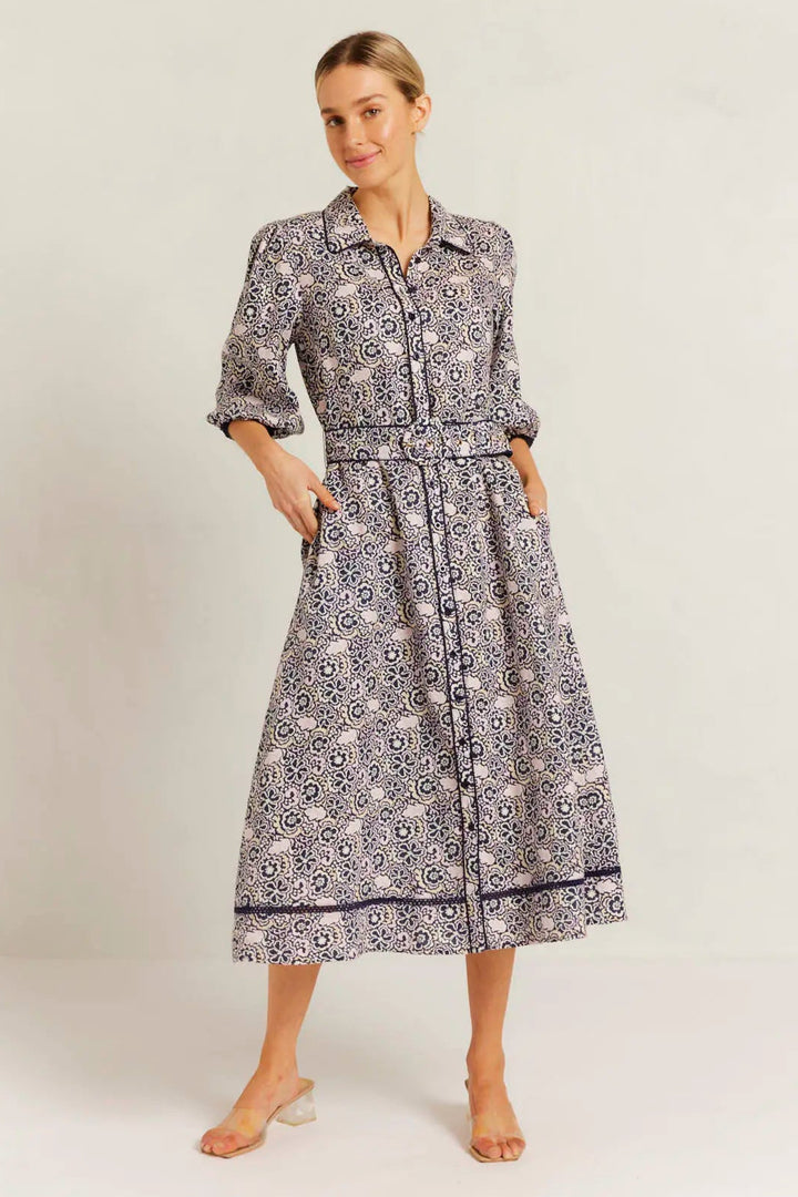 Woman wearing a patterned dress on a white background