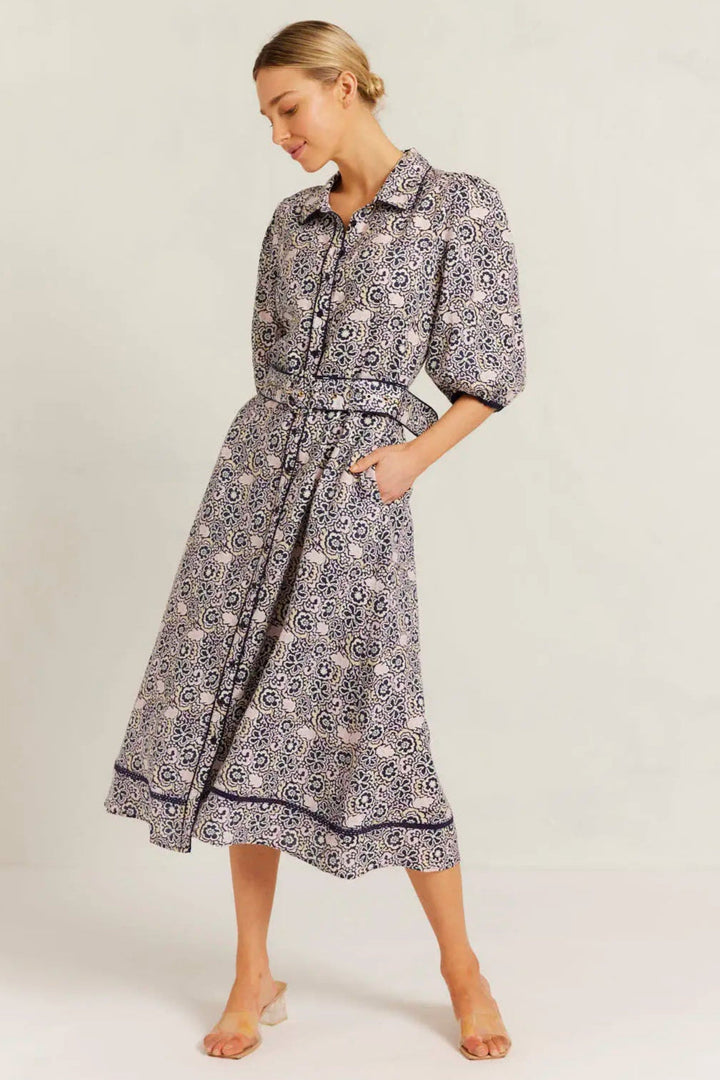Woman wearing a patterned dress on a white background