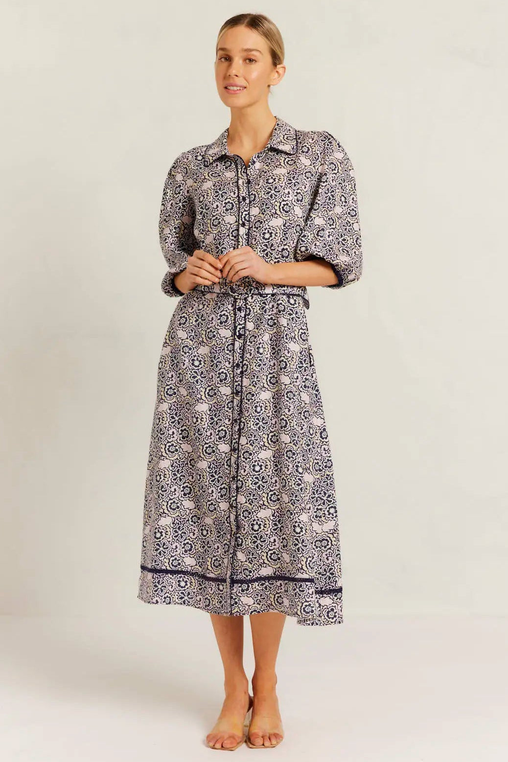 Woman wearing a patterned dress on a white background