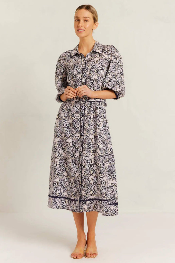 Woman wearing a patterned dress on a white background