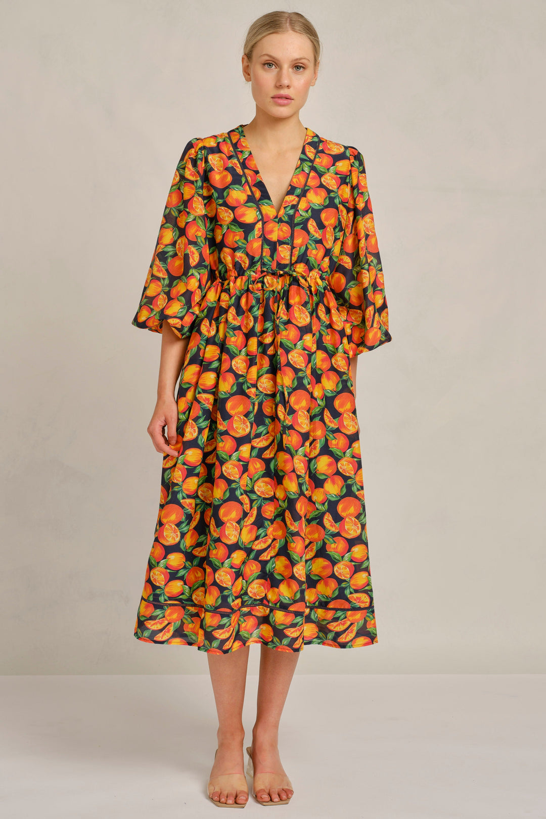 Woman wearing a floral dress on a plain background