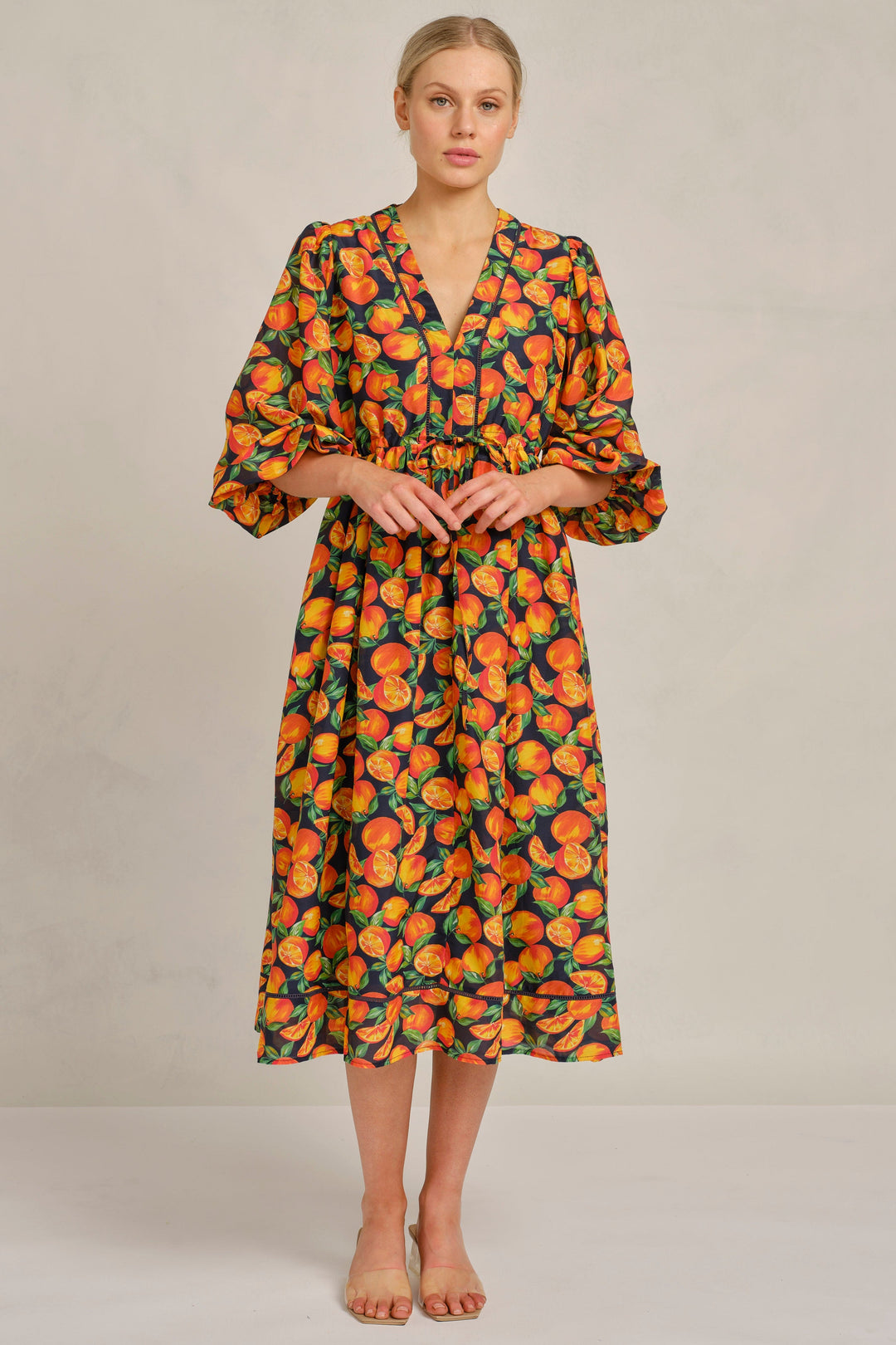 Woman wearing a floral dress on a plain background