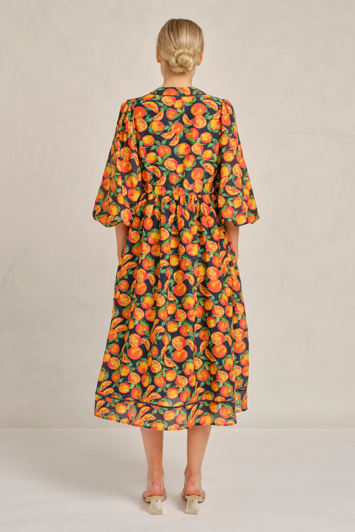 Woman wearing a floral dress with a neutral background