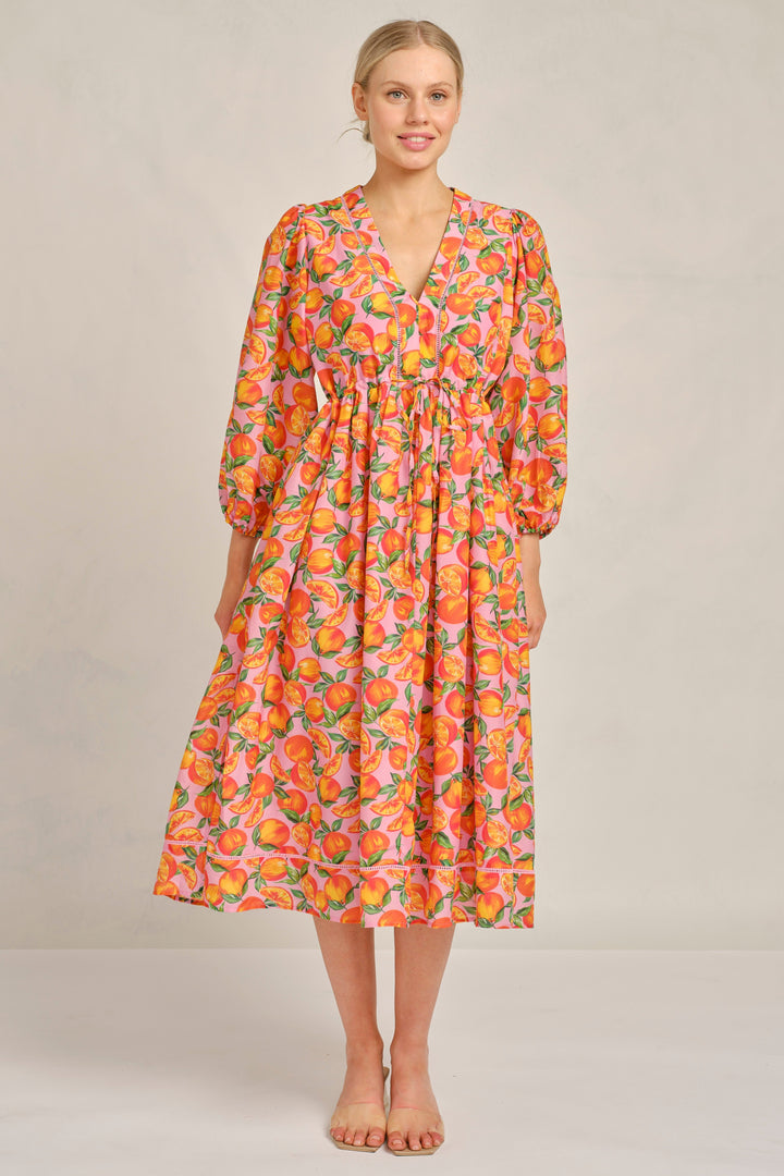 Woman wearing a floral dress on a plain background