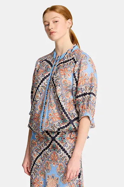 Woman wearing a patterned dress on a white background