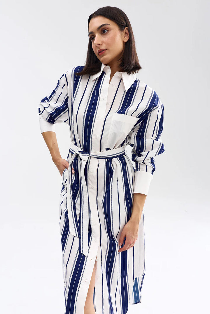 Woman wearing a blue and white striped dress on a white background