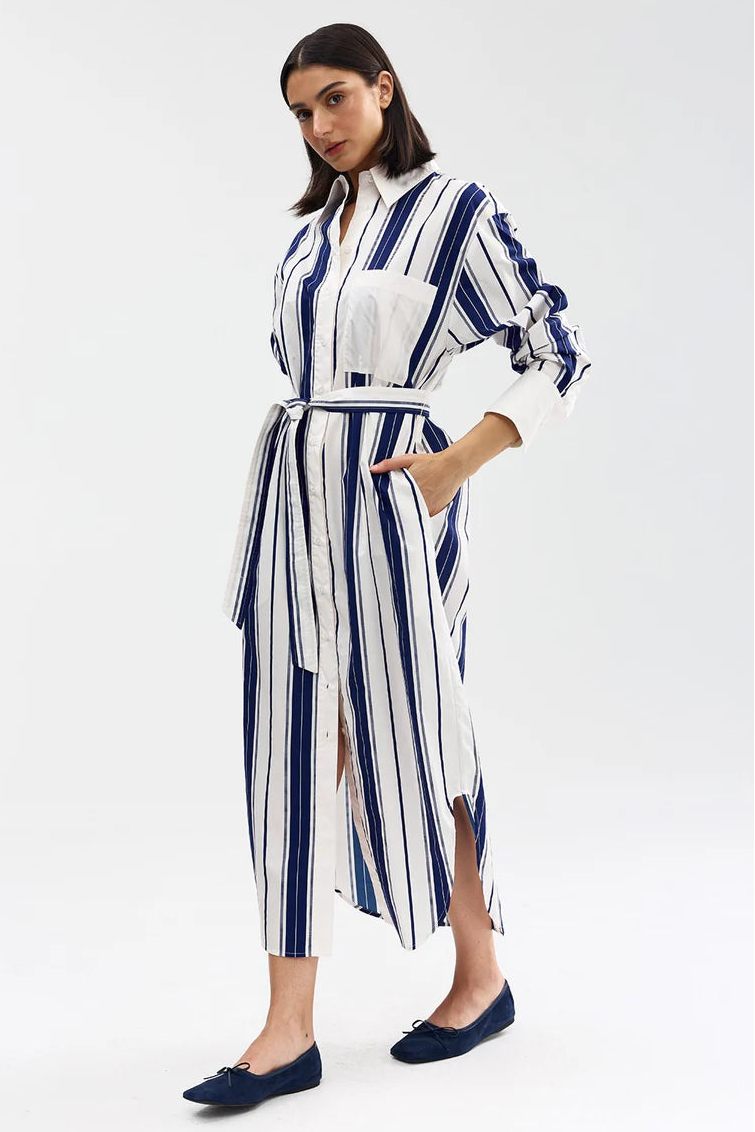 Woman wearing a blue and white striped dress on a white background