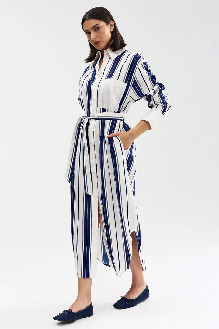 Woman wearing a blue and white striped dress on a white background