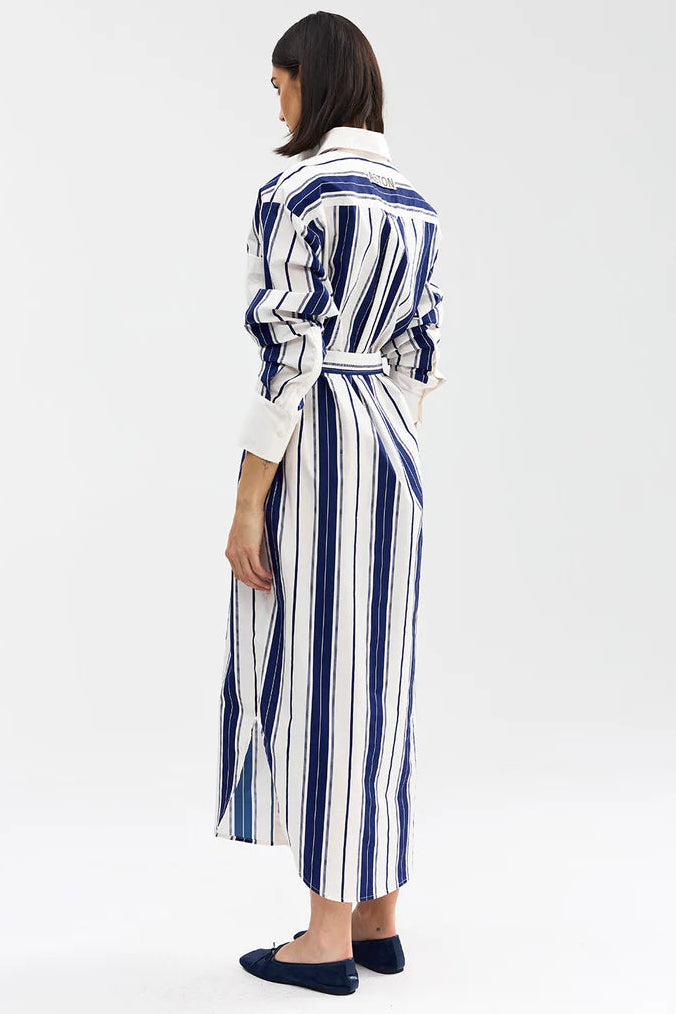 Woman wearing a blue and white striped dress on a white background