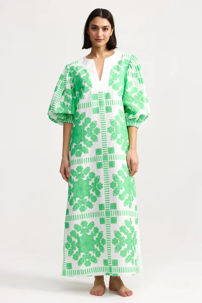 Woman wearing a green and white patterned dress on a white background. Aston Studio Doris Dress Mediterranean Fern