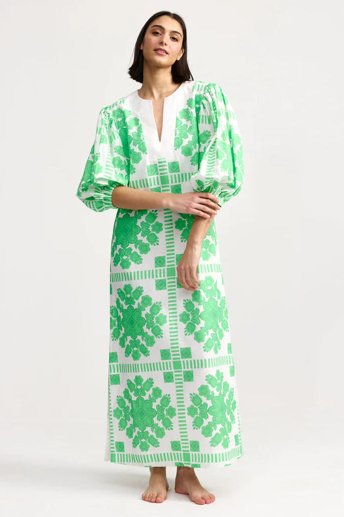 Woman wearing a green and white patterned dress on a white background. Aston Studio Doris Dress Mediterranean Fern