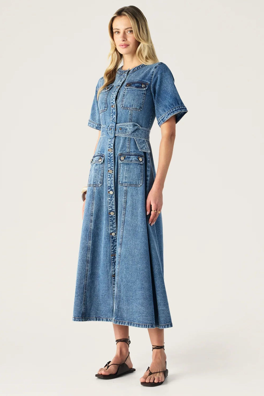 Woman wearing a blue denim dress on a white background