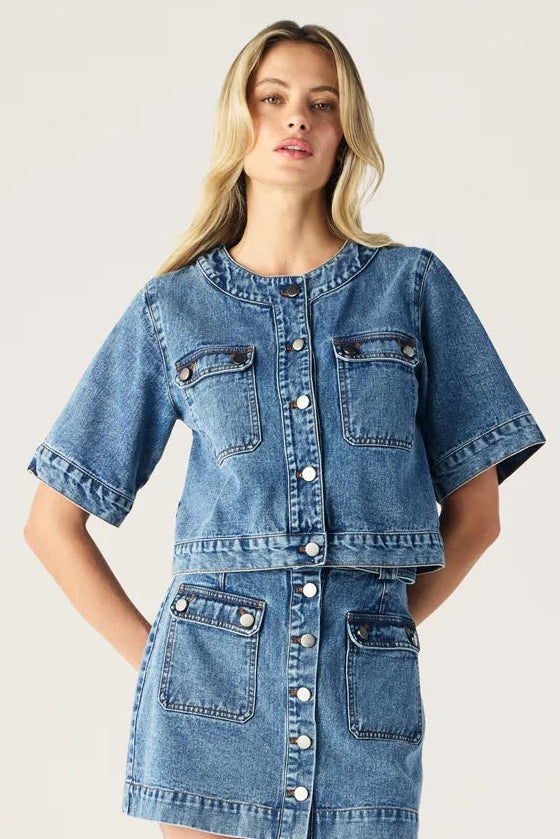 Woman wearing a denim dress on a white background