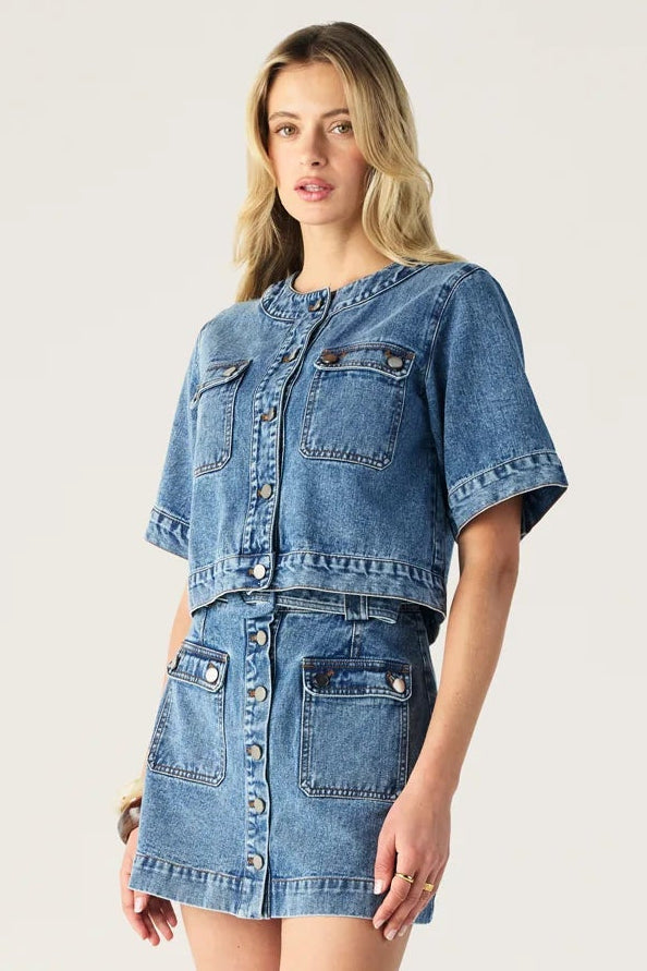 Woman wearing a denim outfit on a white background