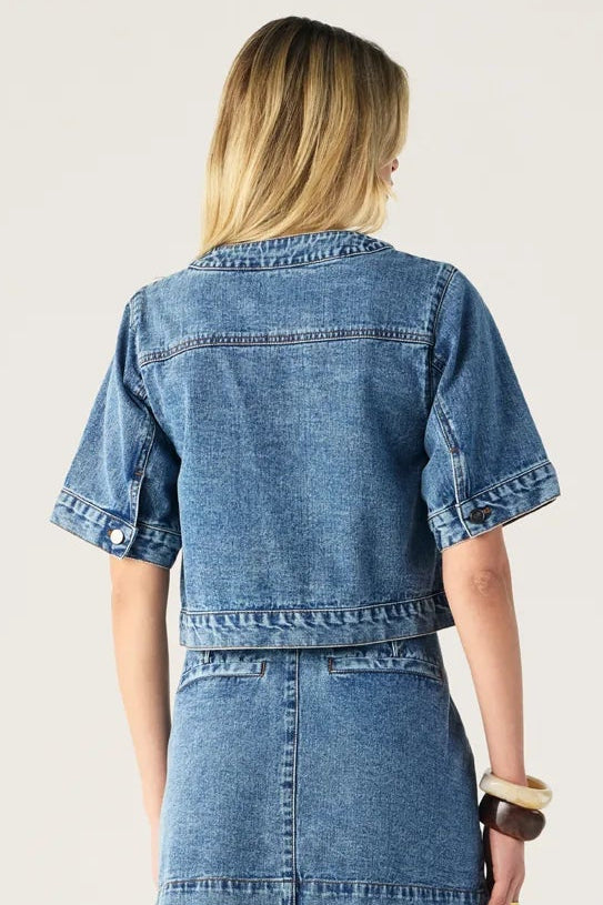 Woman wearing a denim outfit on a white background