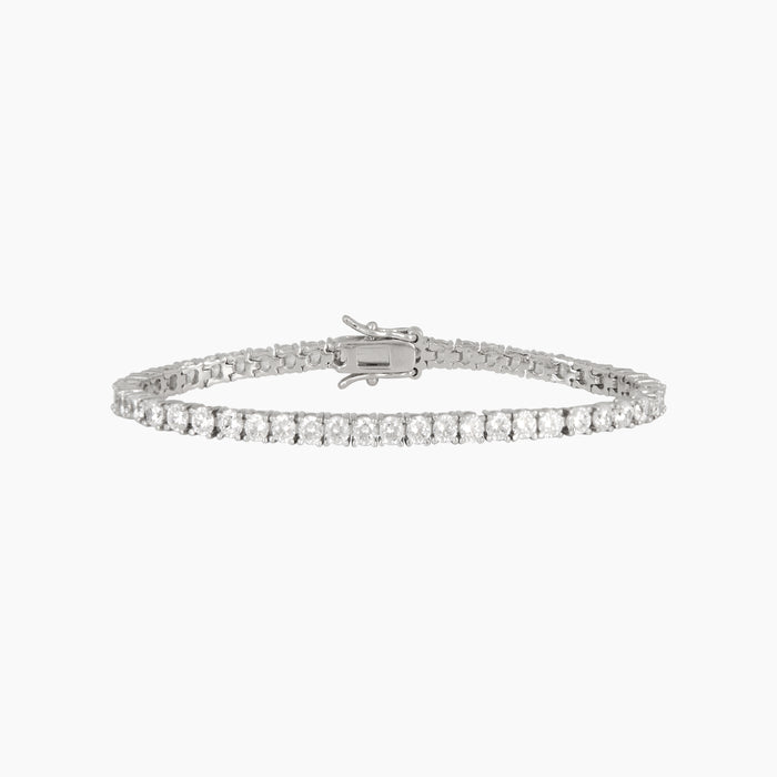 Silver bracelet with green beads on a white background