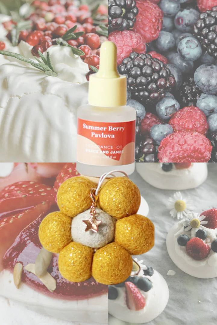 Bottle of 'Summer Berry Pavlova' with a yellow flower-shaped keychain on a background of berries and desserts.