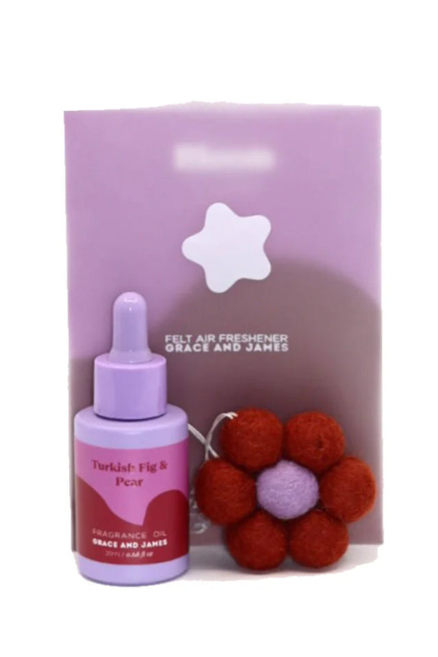 Fragranced oil bottle with dropper and flower shaped felt air freshener on a white background