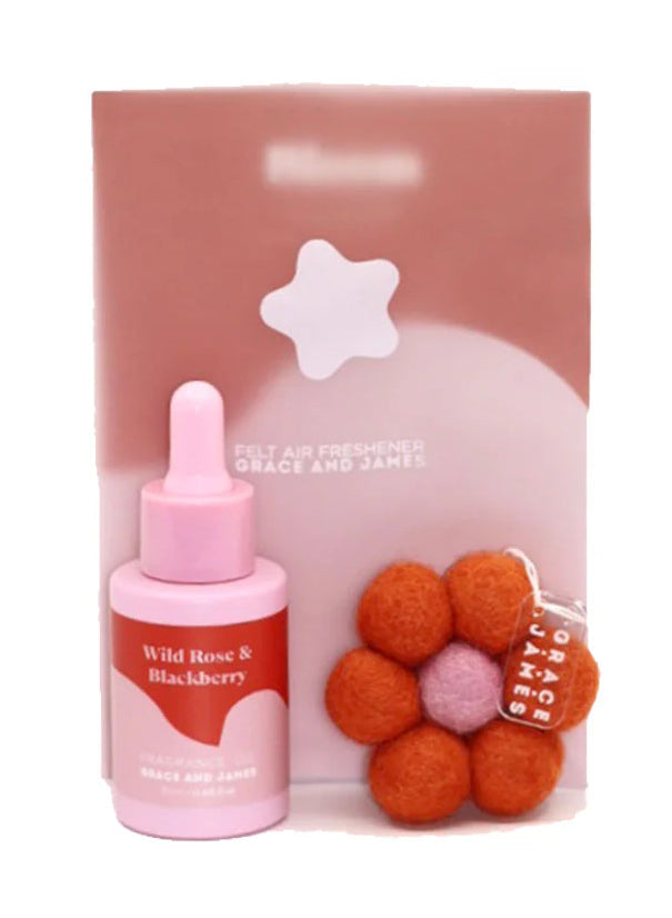 Fragranced oil dropper bottle with a flower shaped felt air freshener on a white background