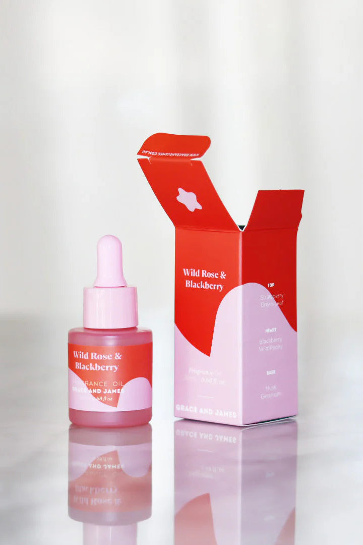 Fragranced oil dropper bottle and red packaging box on a white background
