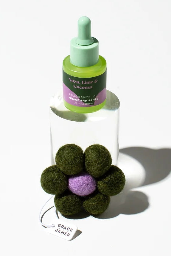 Flower-shaped felt air freshener and oil container on a white background. Yuzu Lime & Coconut