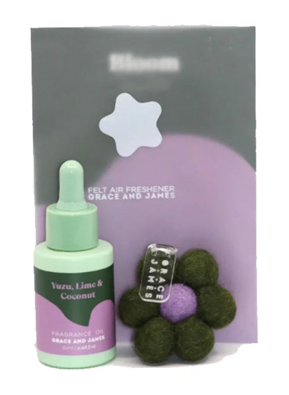 Green bottle with oil dropper and flower shaped felt air freshener on a white background. Yuzu Lime & Coconut