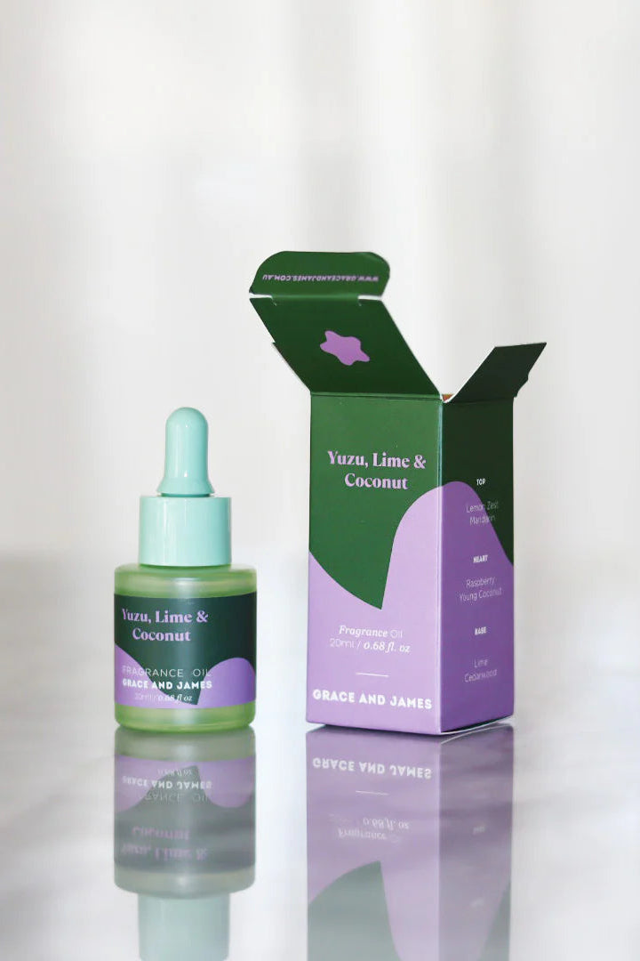 Frangranced oil dropper bottle and packaging with 'Yuzu, Lime & Coconut' on a white background