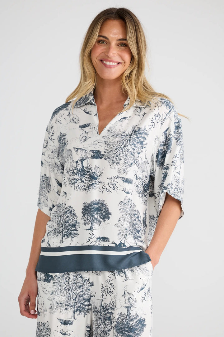 Woman wearing a floral pajama set on a white background