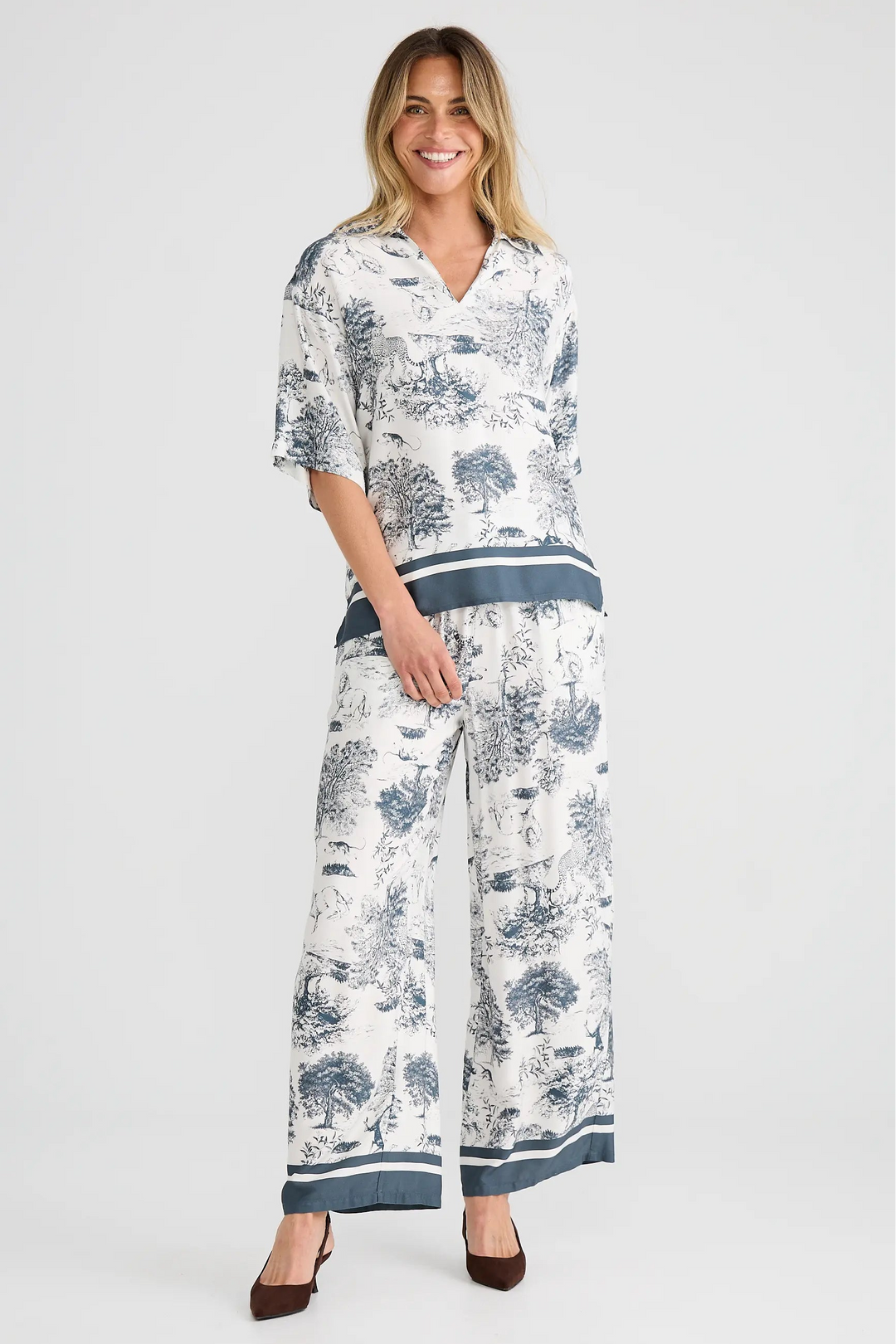 Woman wearing a floral outfit on a white background