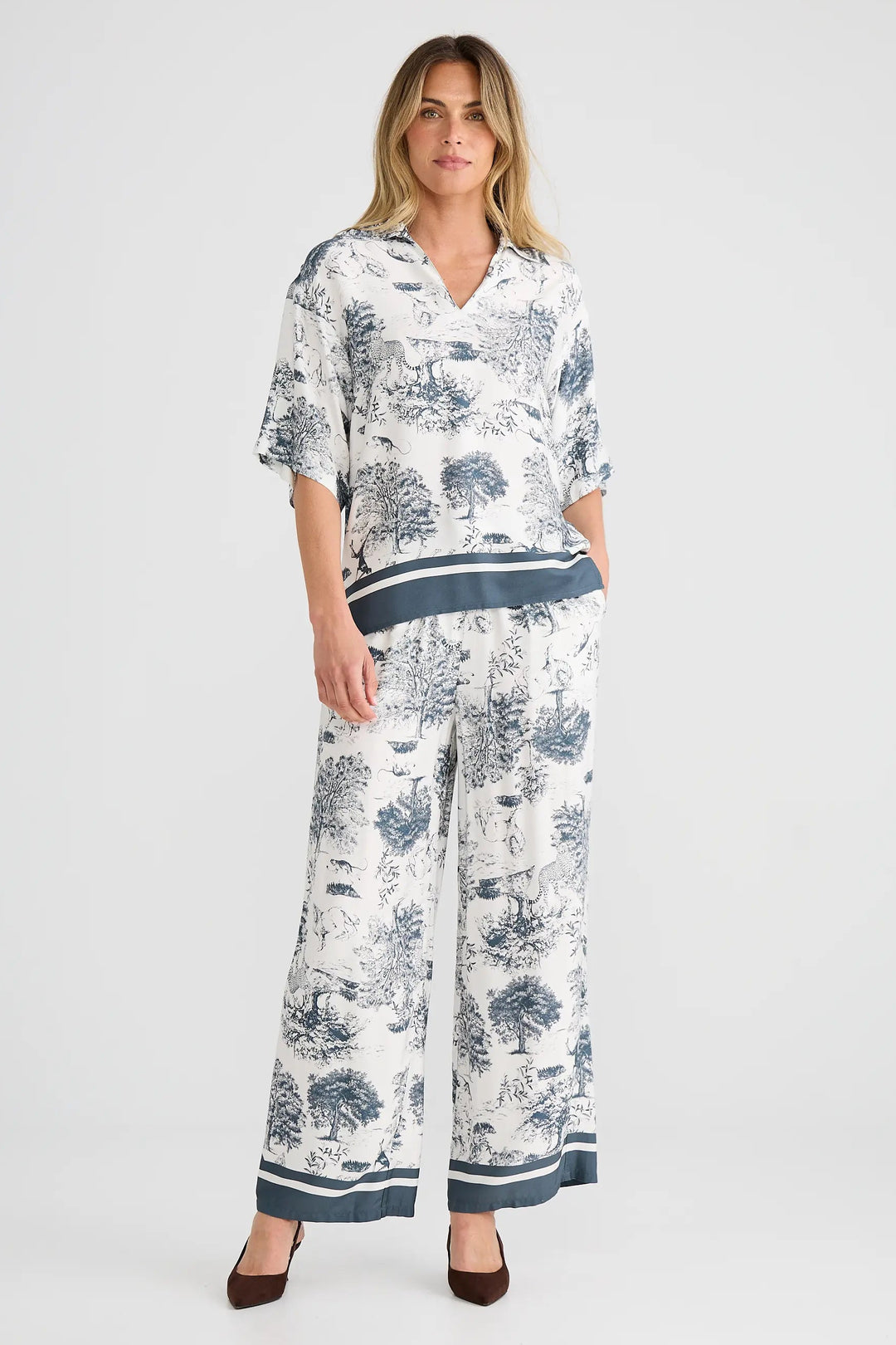 Woman wearing a floral print outfit on a white background