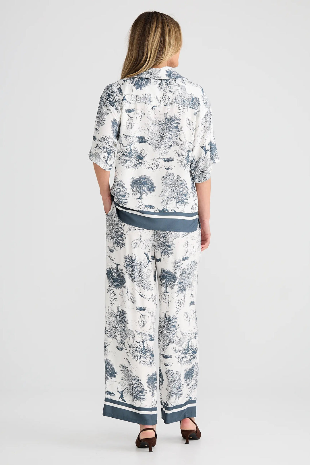 Woman wearing a patterned outfit on a white background