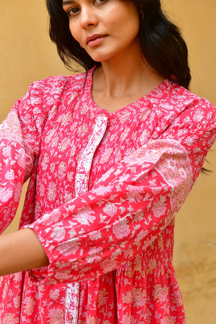 Woman wearing a red floral dress against a beige background - Azure & Indigo Camillia Maxi Dress Cherry.
