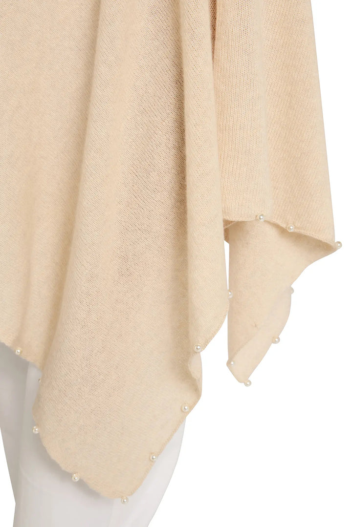 Beige knitted shawl on a mannequin with a white background