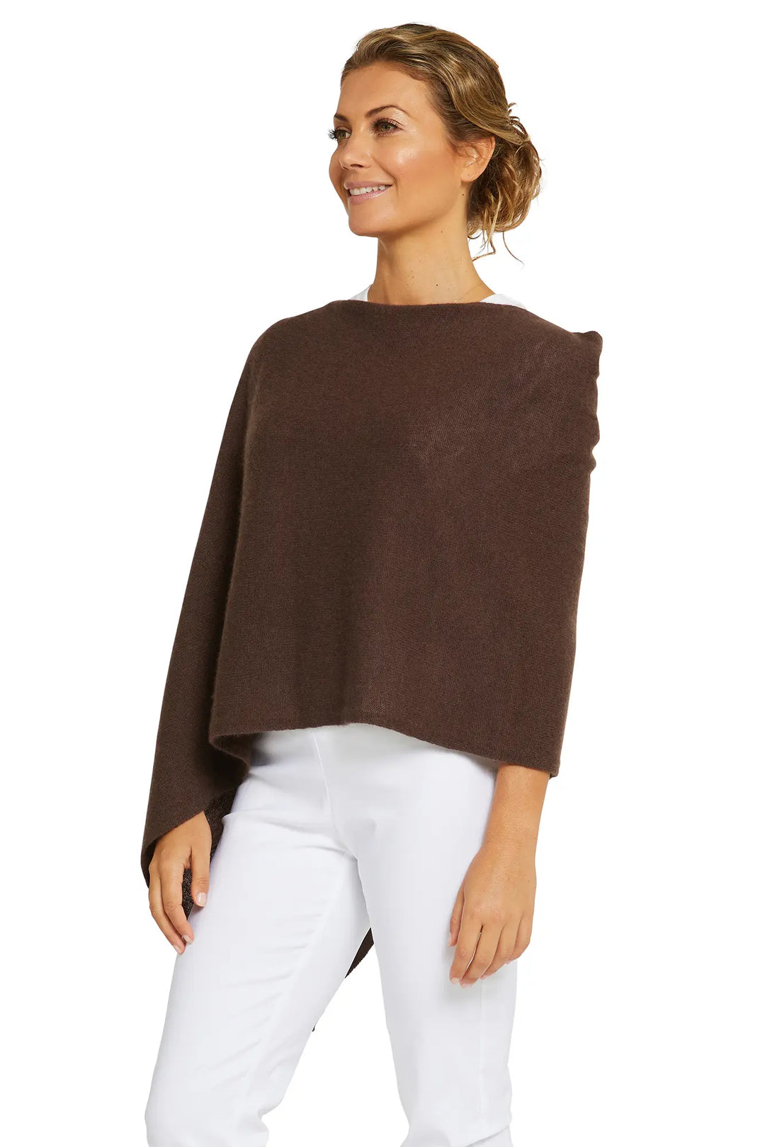 Woman wearing a brown poncho over a white outfit on a white background