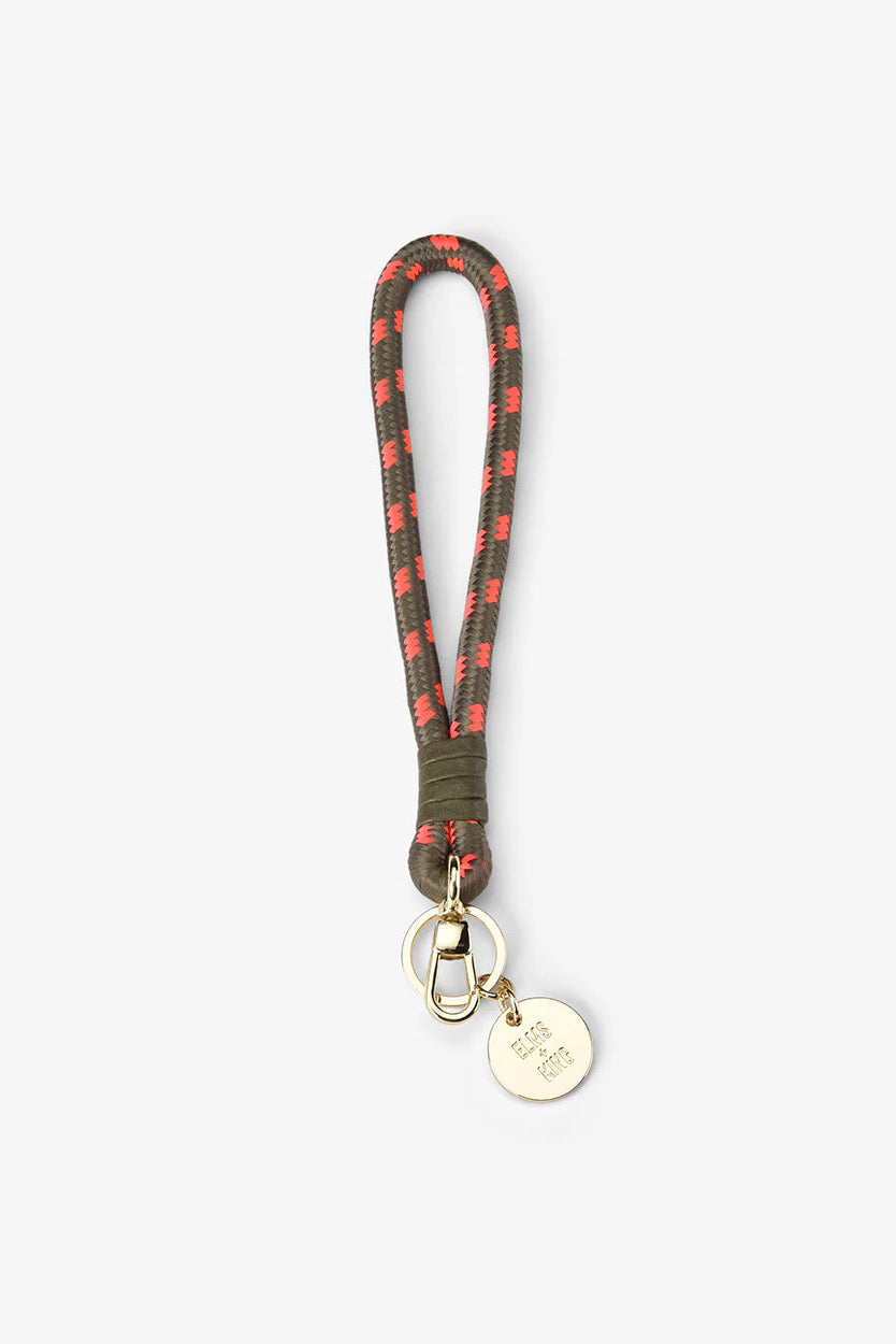 Keychain with plaid pattern and gold tag on a white background