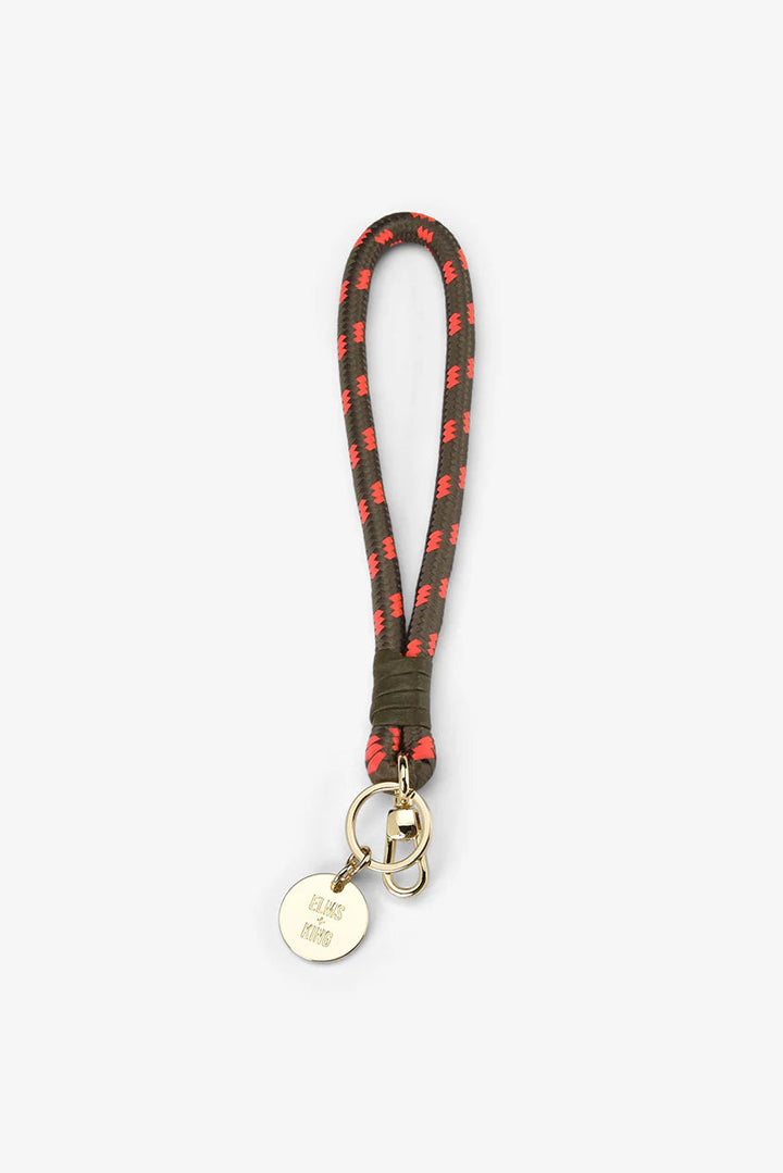 Keychain with green strap and red accents on a white background